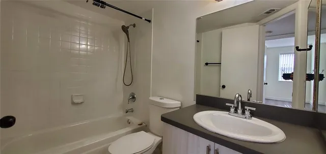 a bathroom with a sink toilet tub and shower