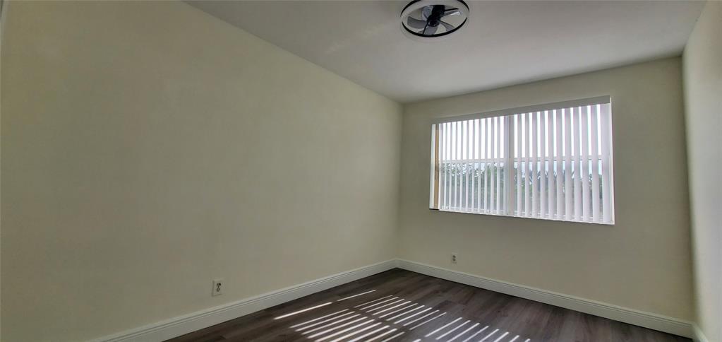 8781 Wiles Road, Unit 308 Coral Springs, FL 33067 - Photo 16 of 24 an empty room with a window