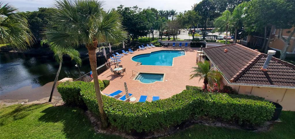 8781 Wiles Road, Unit 308 Coral Springs, FL 33067 - Photo 20 of 24 an aerial view of a house with outdoor space swimming pool and outdoor seating