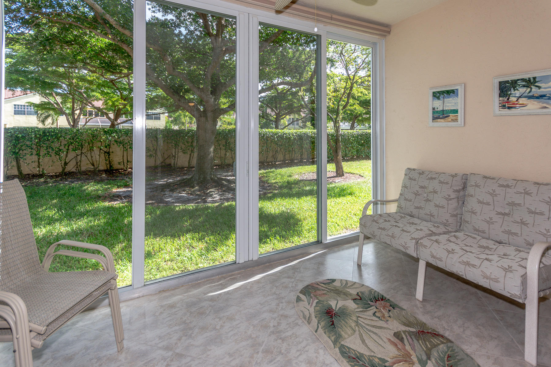17050 Emile Street, Unit 4 Boca Raton, FL 33487 - Photo 7 of 32 a living room with a large window and floor to ceiling window