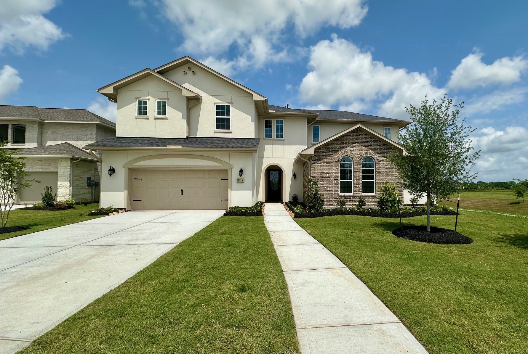 a front view of a house with a yard and garage