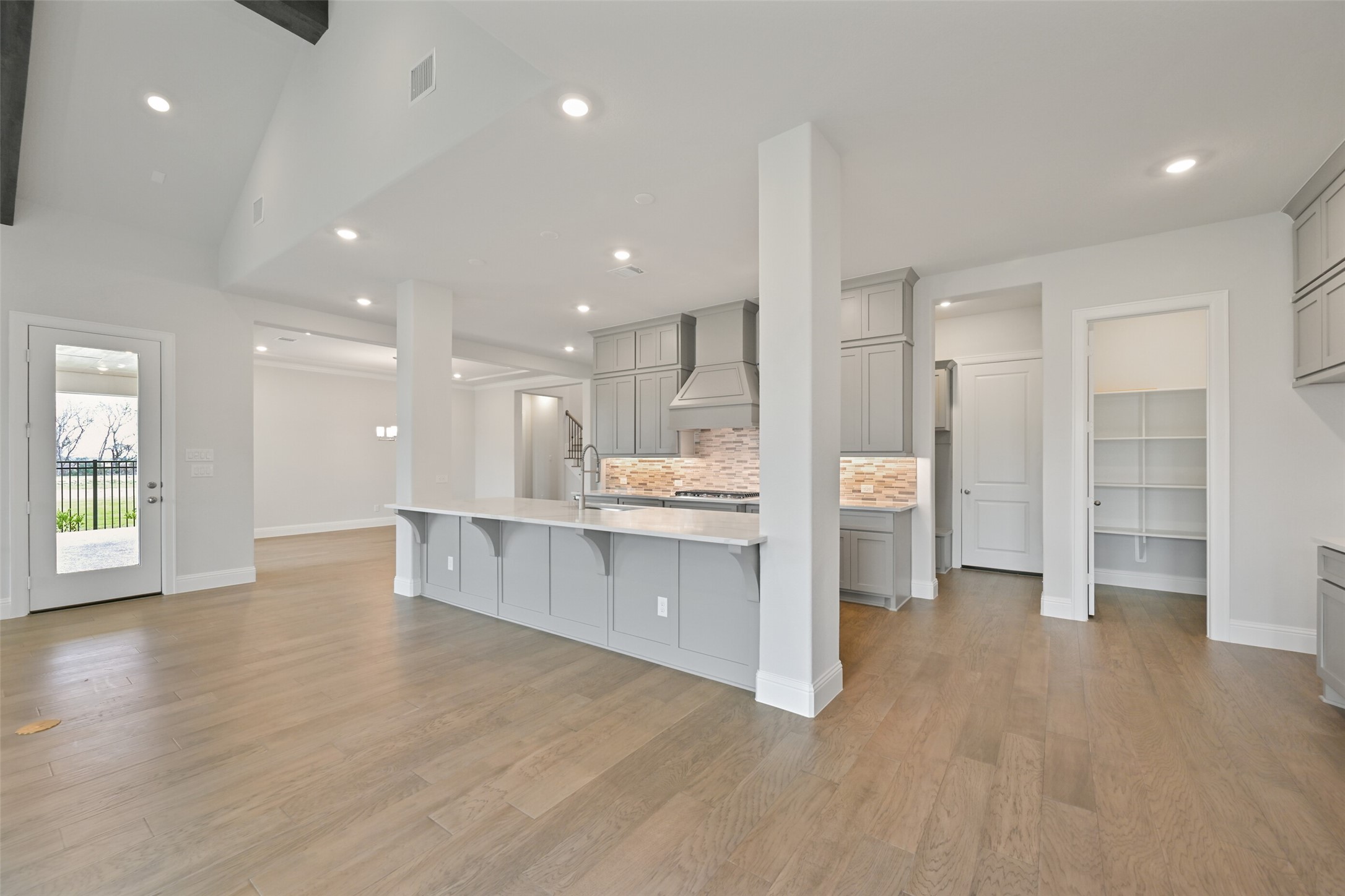 5215 Conifer Court Manvel, TX 77578 - Photo 11 of 49 a open kitchen with white cabinets and wooden floors