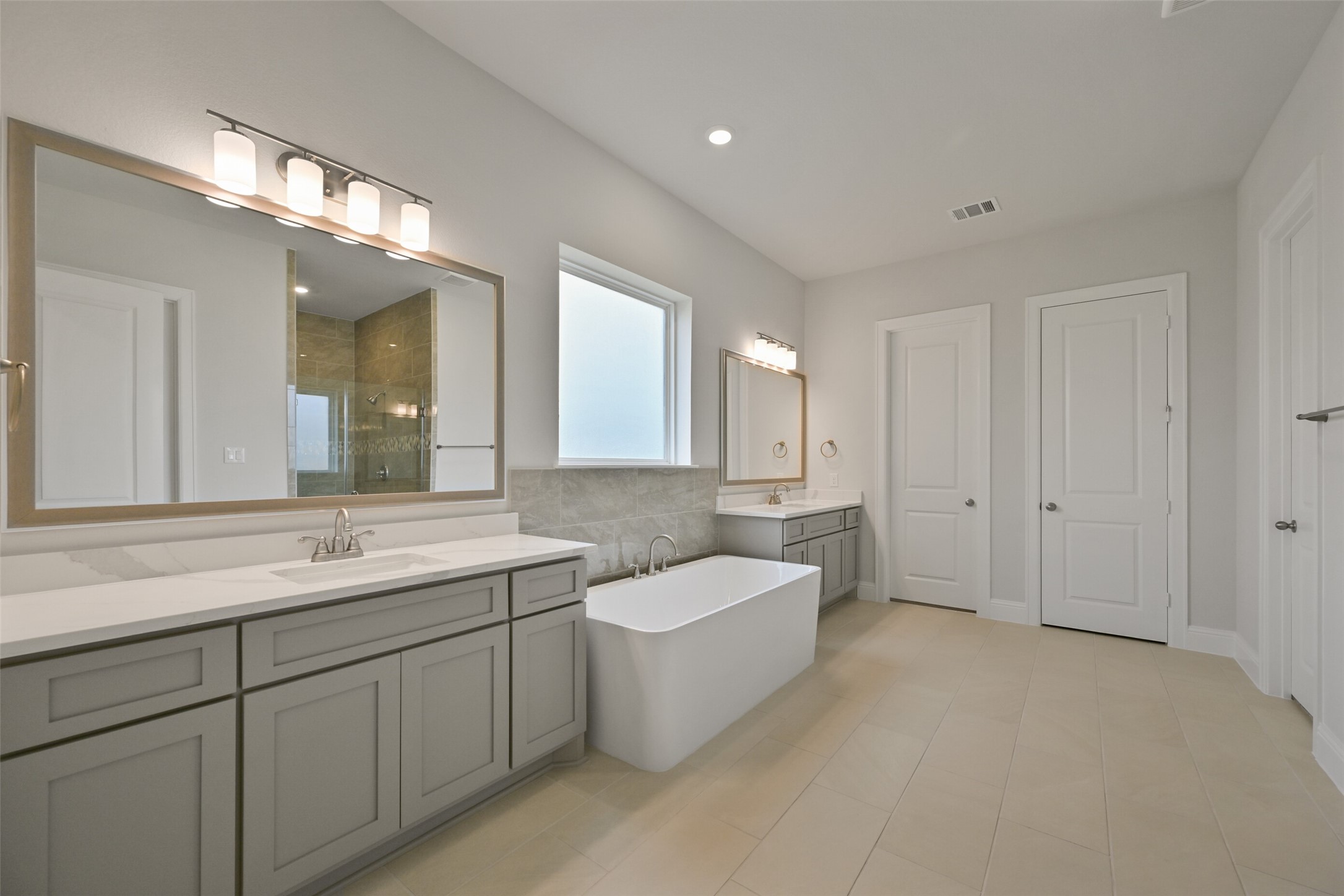 5215 Conifer Court Manvel, TX 77578 - Photo 20 of 49 a spacious bathroom with a double vanity sink mirror and bathtub