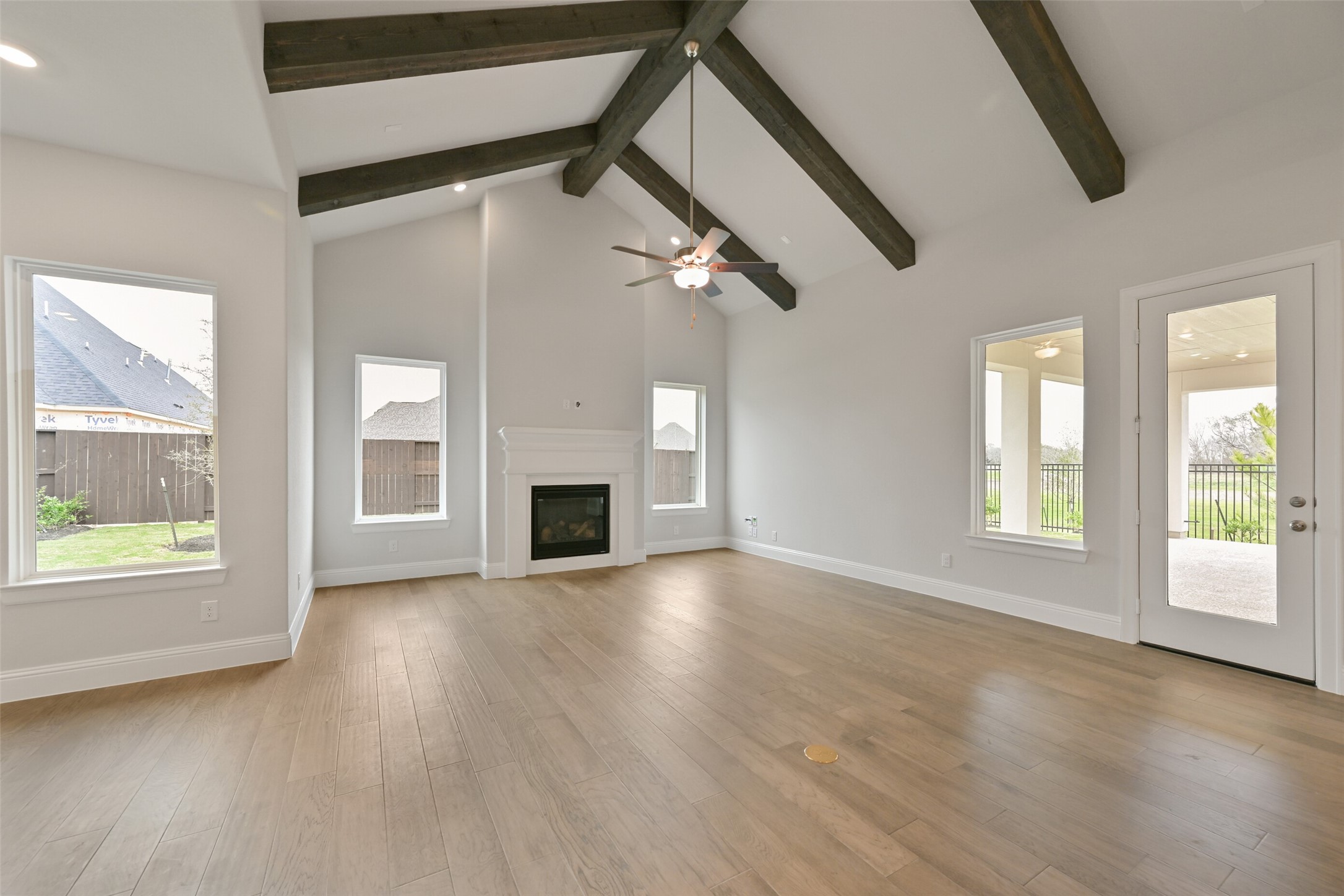 5215 Conifer Court Manvel, TX 77578 - Photo 4 of 49 an empty room with wooden floor fan and windows