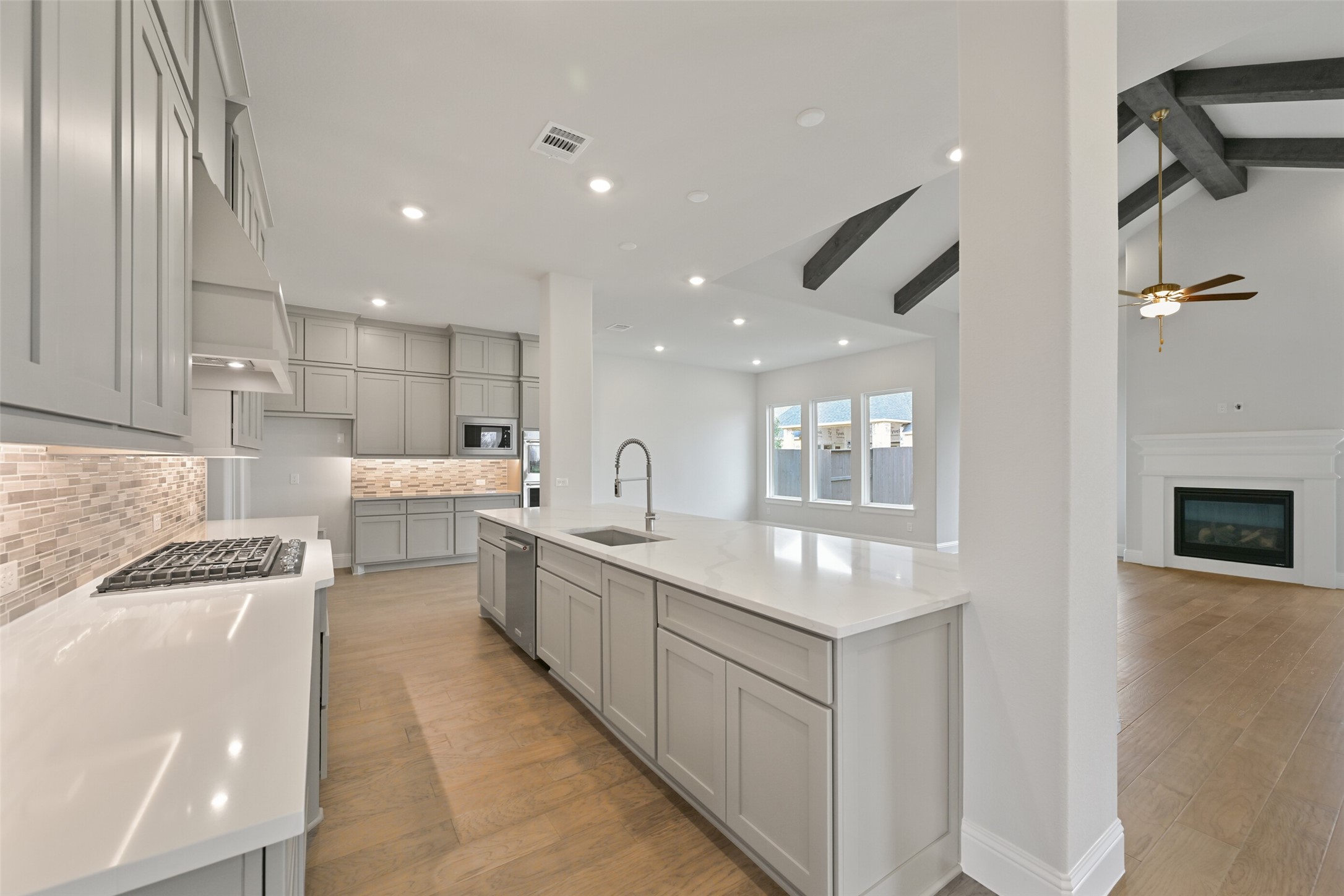 5215 Conifer Court Manvel, TX 77578 - Photo 7 of 49 a large white kitchen with lots of counter space wooden floor and stainless steel appliances