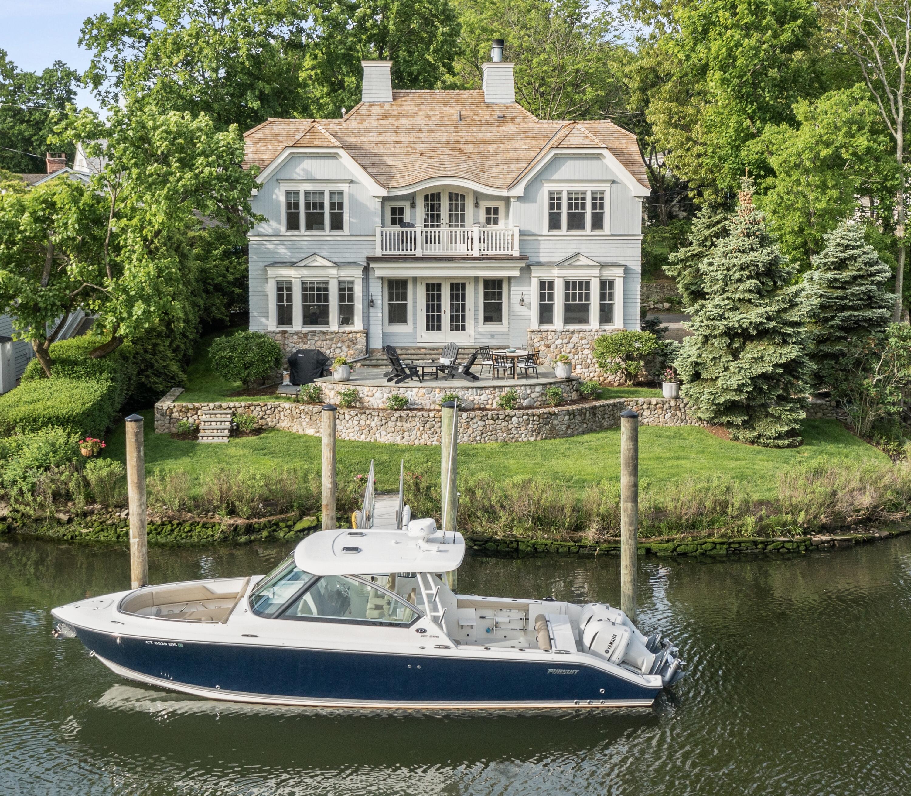 a front view of a house with a yard table and chairs