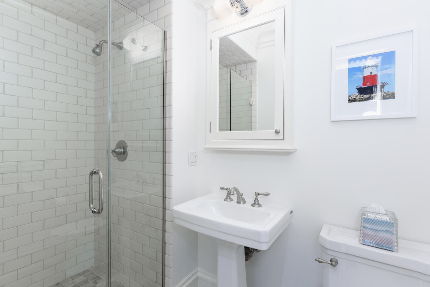 59 5 Mile River Road Darien, CT 06820 - Photo 19 of 39 a bathroom with a sink mirror and a shower