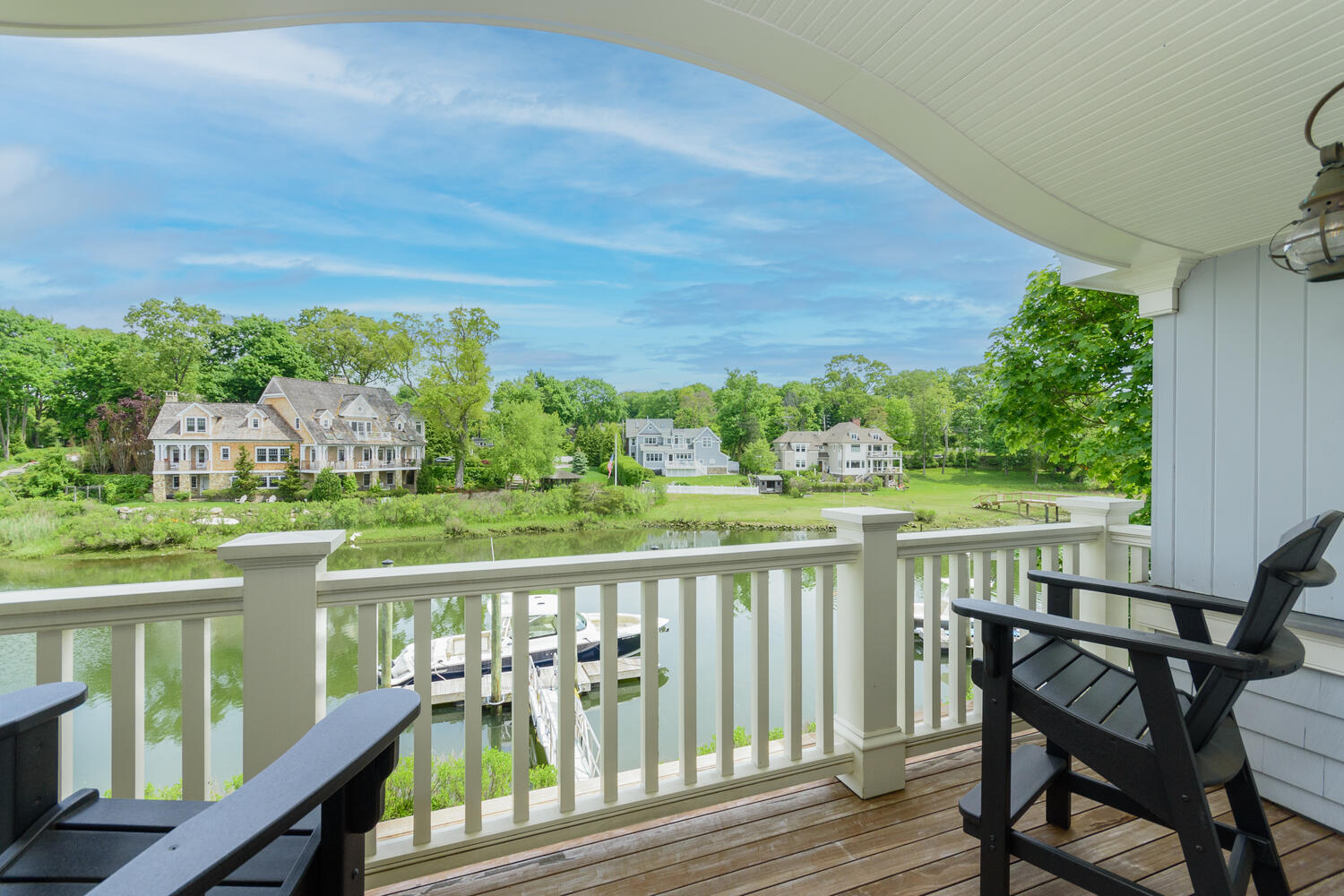 59 5 Mile River Road Darien, CT 06820 - Photo 29 of 39 a view of a chairs on wooden deck with lake view