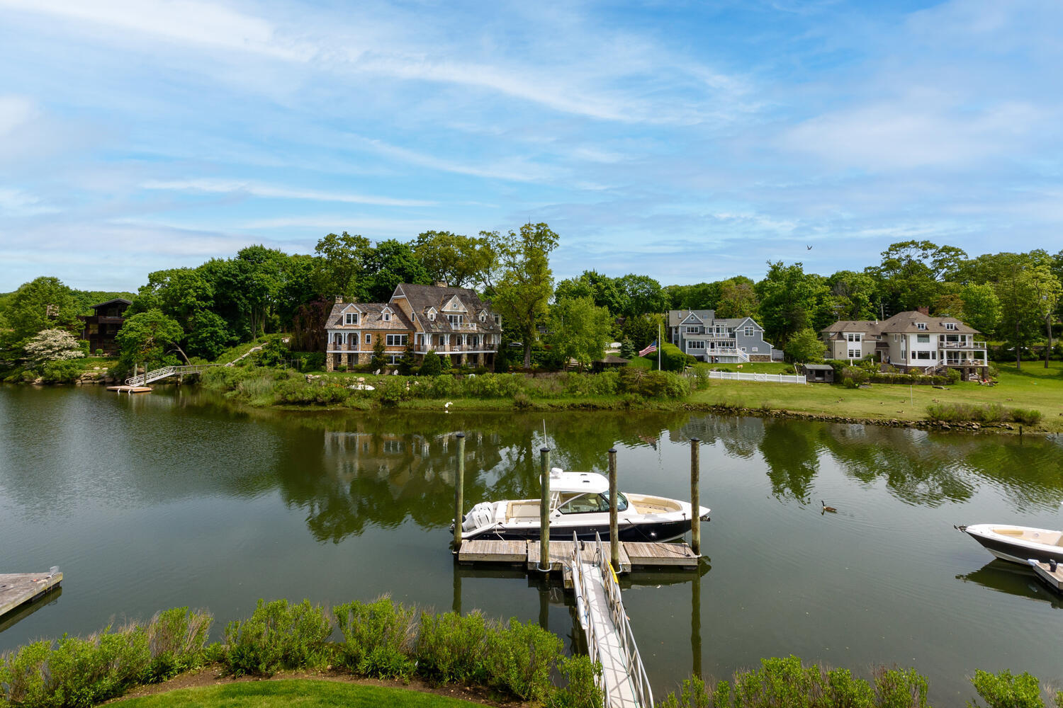 59 5 Mile River Road Darien, CT 06820 - Photo 30 of 39 a view of a lake with houses in the back