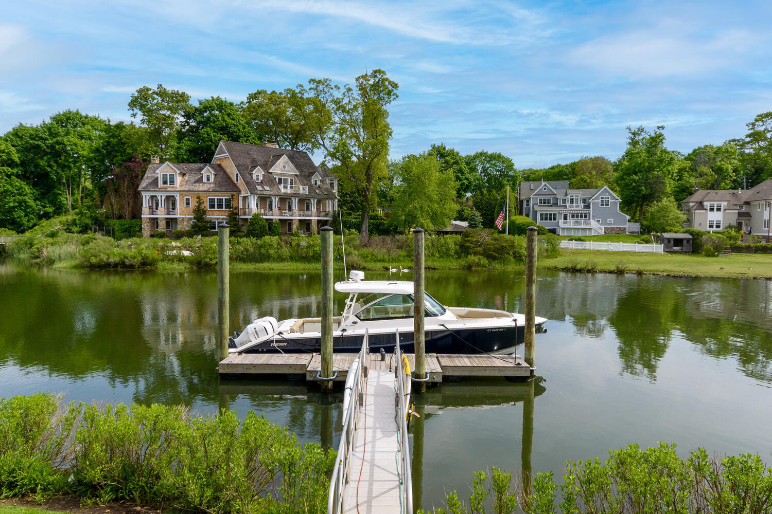 59 5 Mile River Road Darien, CT 06820 - Photo 33 of 39 a view of a lake with a house in the background