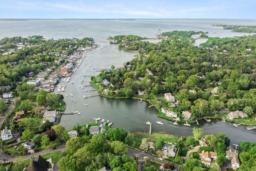 59 5 Mile River Road Darien, CT 06820 - Photo 39 of 39 a view of a lake with a yard and potted plants