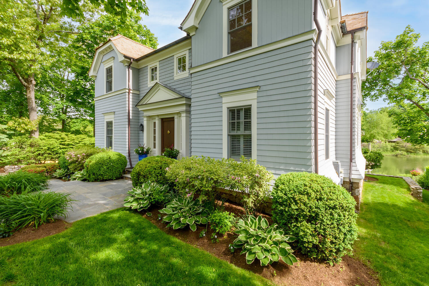 59 5 Mile River Road Darien, CT 06820 - Photo 4 of 39 a view of a house with a yard and potted plants