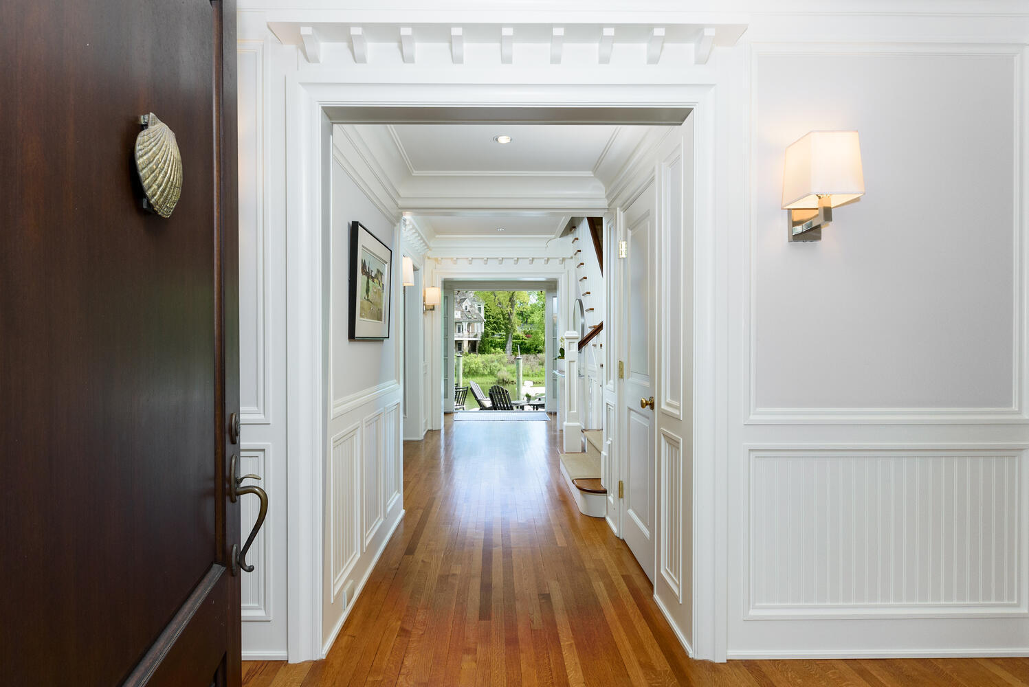 59 5 Mile River Road Darien, CT 06820 - Photo 5 of 39 a view of a hallway with wooden floor and staircase