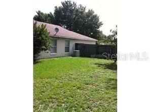 a view of a house with a yard and a garage