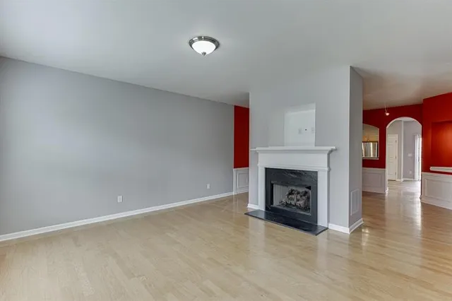 a view of an empty room with a fireplace