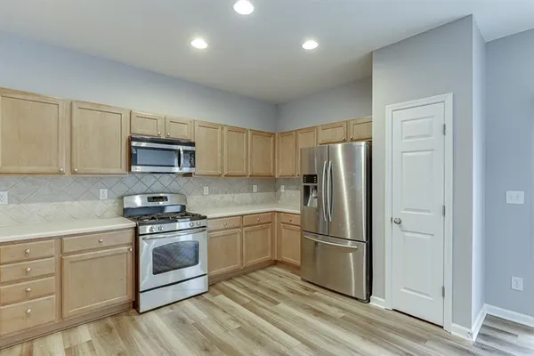 a kitchen with cabinets a sink and stainless steel appliances