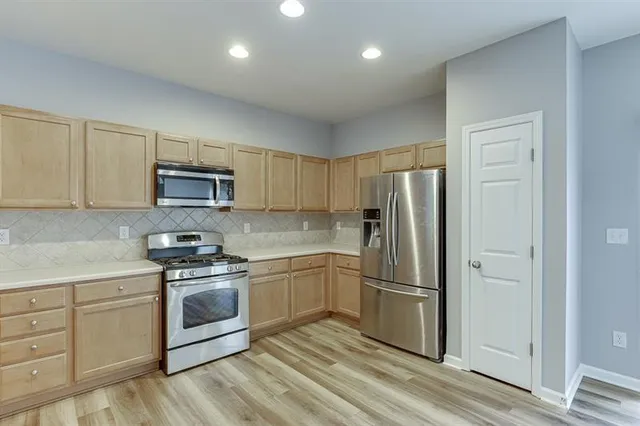 a kitchen with cabinets a sink and stainless steel appliances