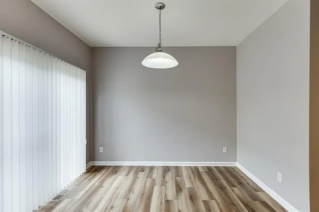 a kitchen with granite countertop a stove a sink and a refrigerator