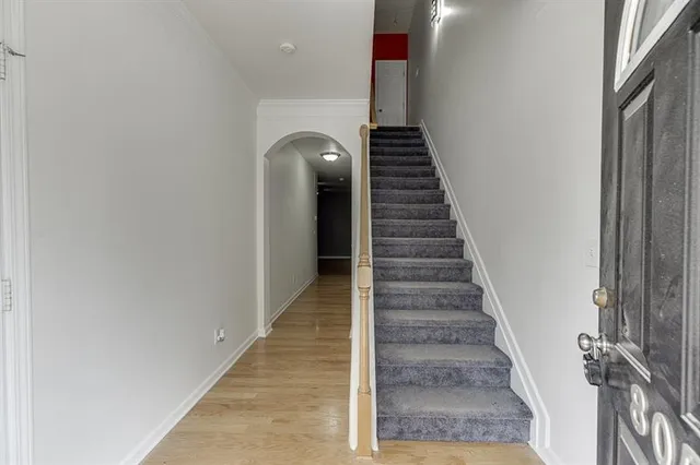 a view of entryway and hall with wooden floor