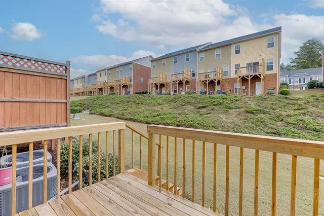 a view of a house with a wooden deck