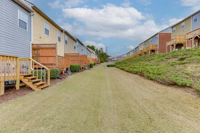 an aerial view of a house with a yard and lake view