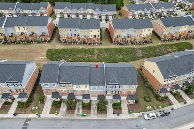 an aerial view of a house with a garden potted plants and large trees