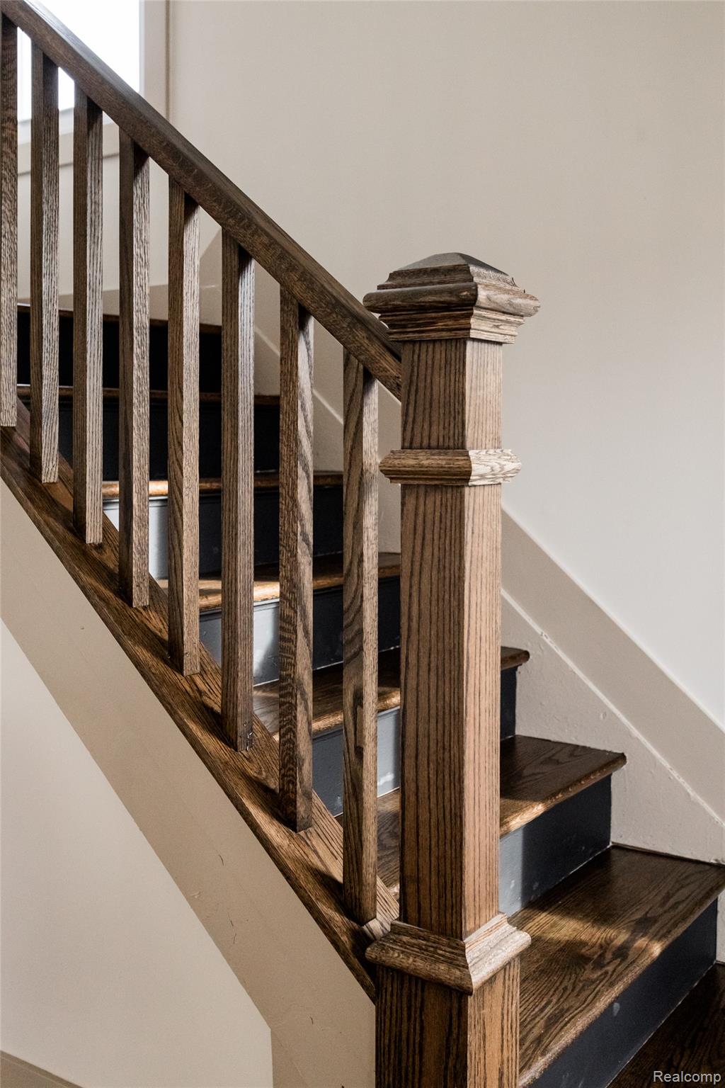 2630 Harding Street Detroit, MI 48214 - Photo 17 of 30 Richly stained wood staircase featuring a robust newel post and balusters