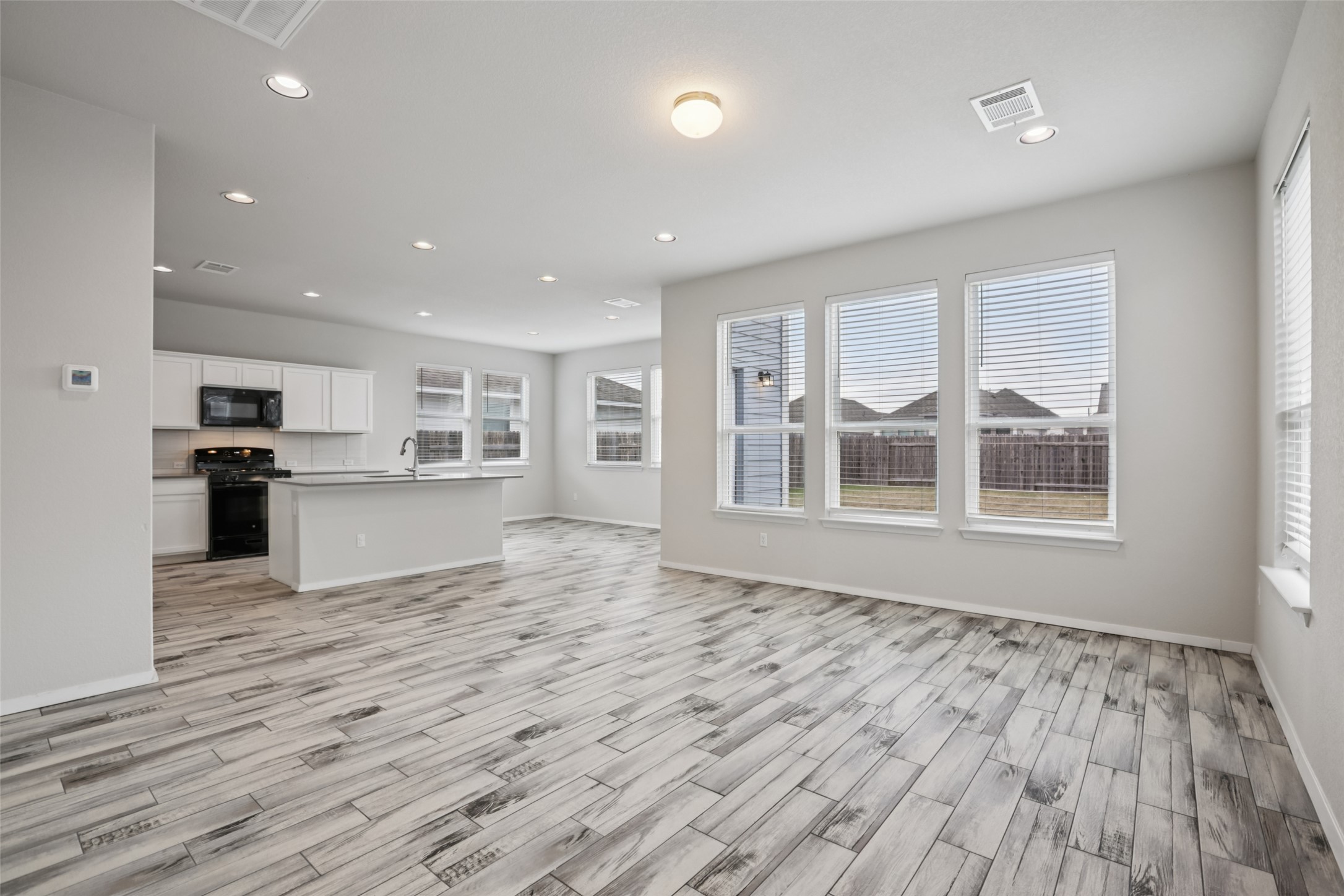 293 Gaida Loop Georgetown, TX 78628 - Photo 11 of 39 a view of kitchen with wooden floor and electronic appliances