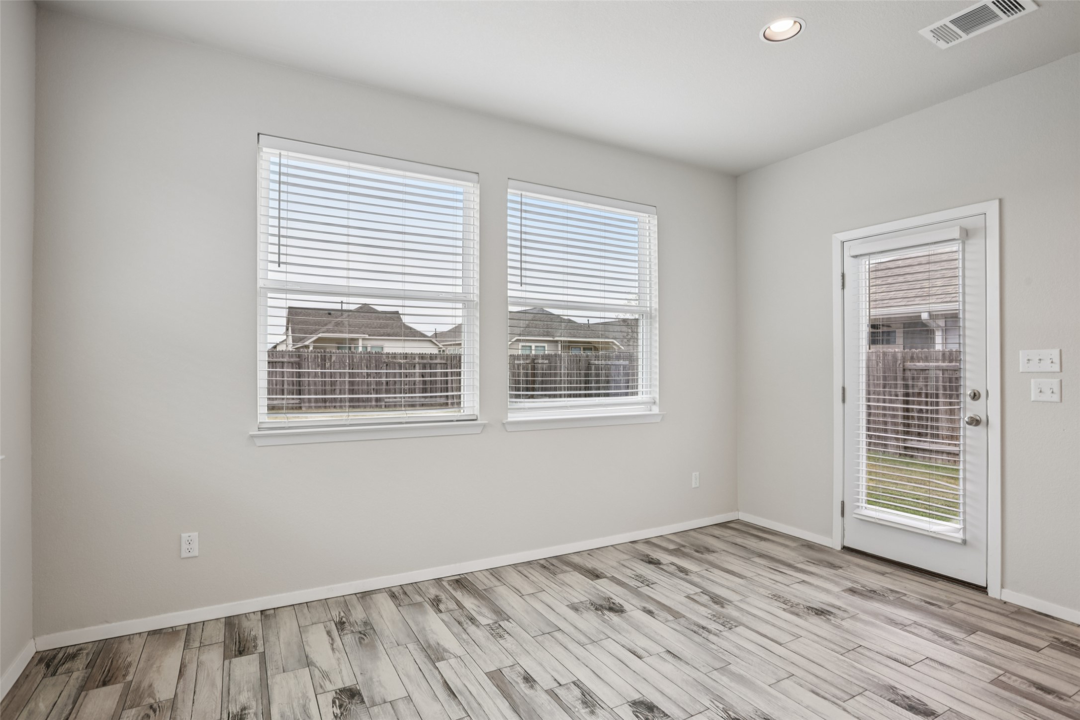 293 Gaida Loop Georgetown, TX 78628 - Photo 13 of 39 a view of an empty room with wooden floor and a window
