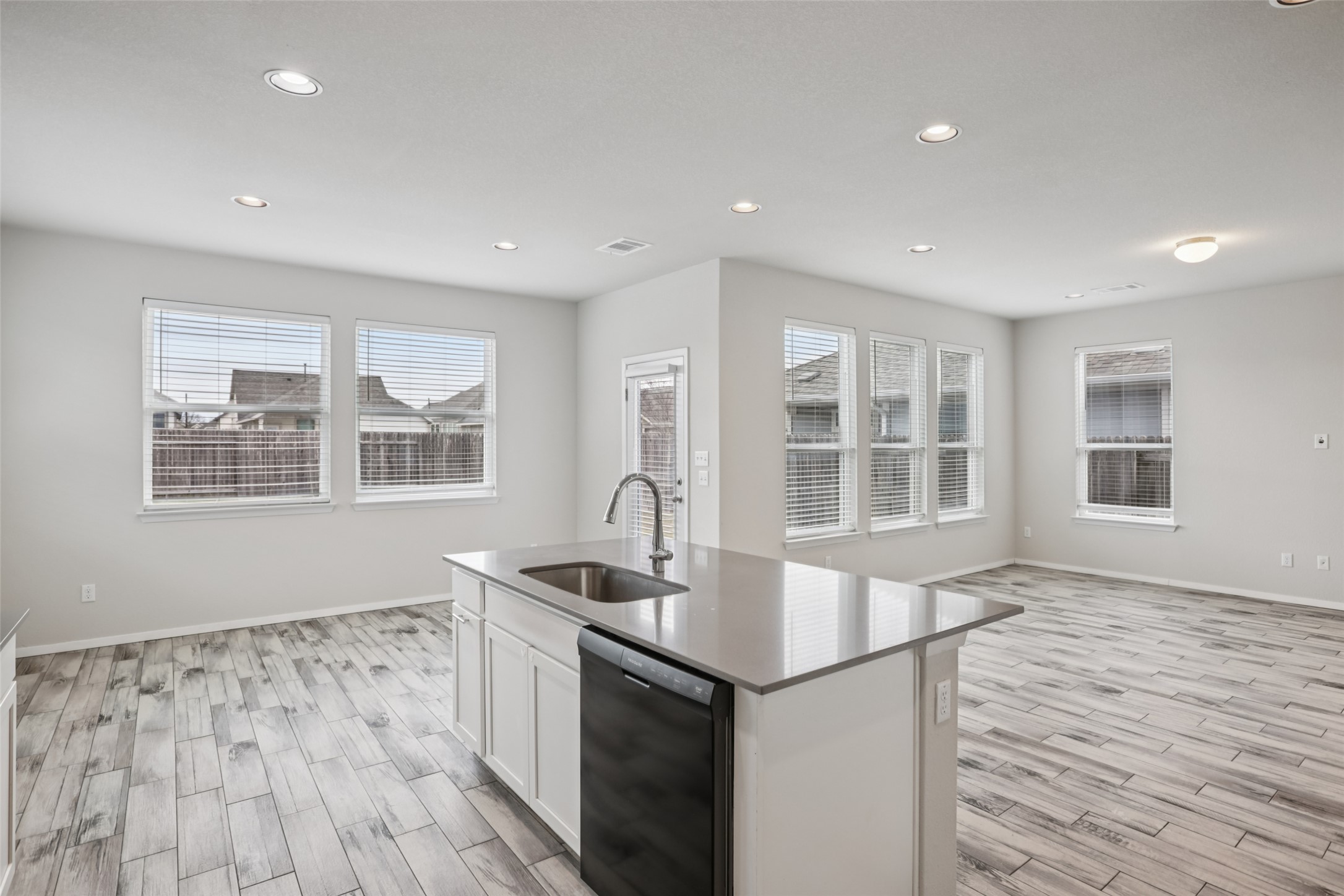 293 Gaida Loop Georgetown, TX 78628 - Photo 16 of 39 a kitchen with stainless steel appliances granite countertop a sink and a stove top oven