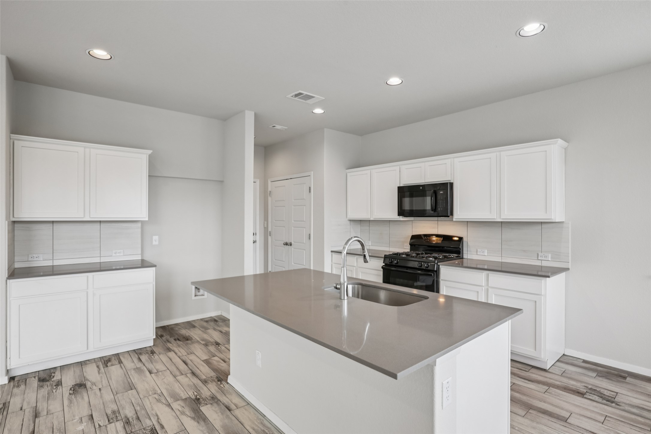 293 Gaida Loop Georgetown, TX 78628 - Photo 2 of 39 a kitchen with stainless steel appliances granite countertop a sink a stove and a refrigerator