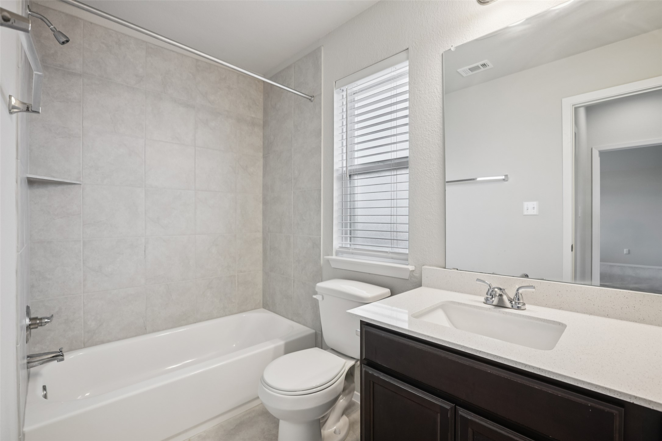 293 Gaida Loop Georgetown, TX 78628 - Photo 23 of 39 a bathroom with a granite countertop sink toilet and shower