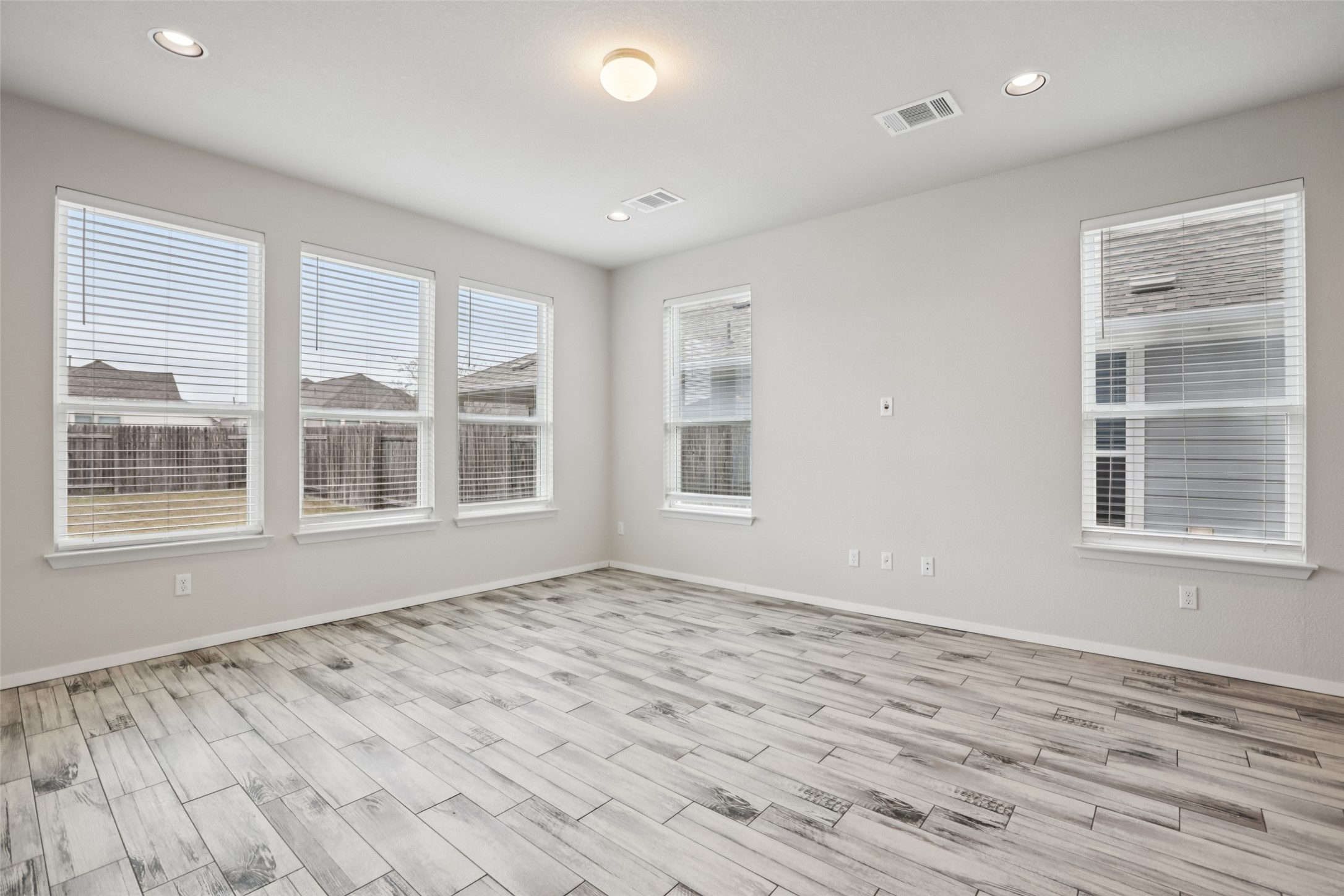 293 Gaida Loop Georgetown, TX 78628 - Photo 26 of 39 a view of an empty room with a window and wooden floor