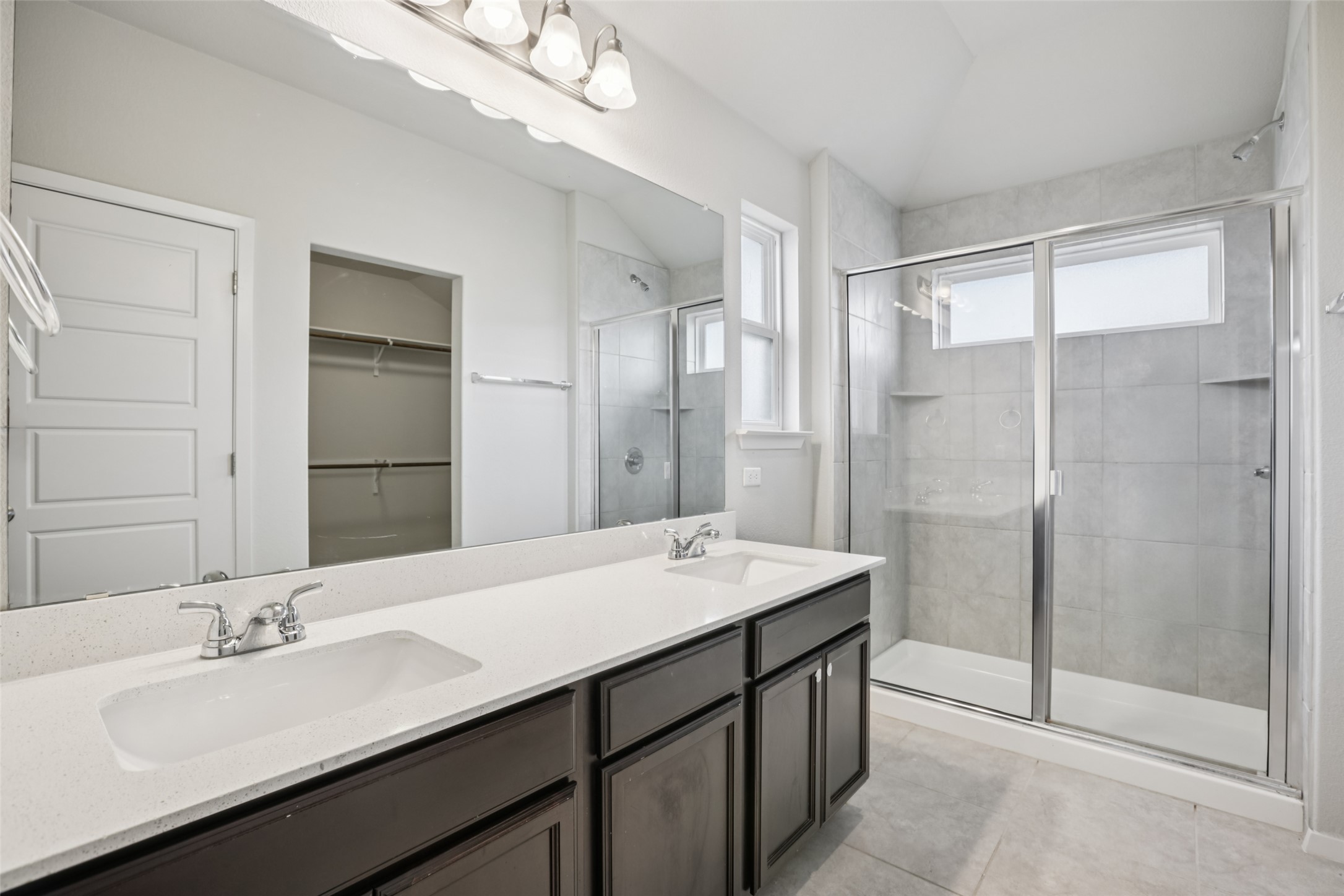 293 Gaida Loop Georgetown, TX 78628 - Photo 6 of 39 a bathroom with a double vanity sink mirror and shower