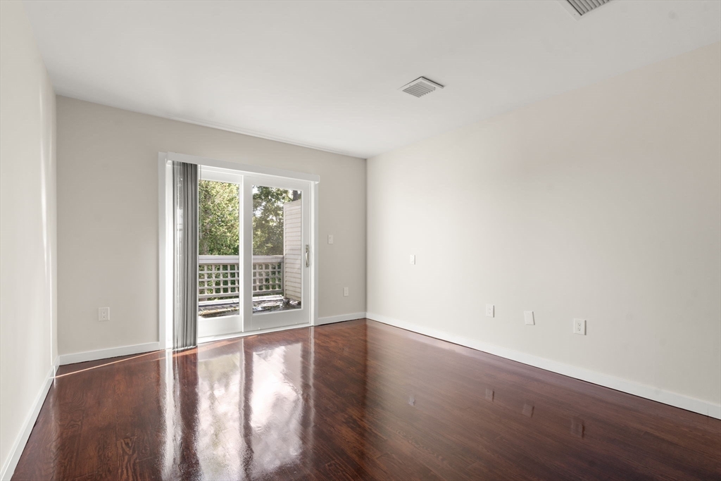 553 Boylston Street, Unit C2 Brookline, MA 02445 - Photo 17 of 31 an empty room with wooden floor and windows