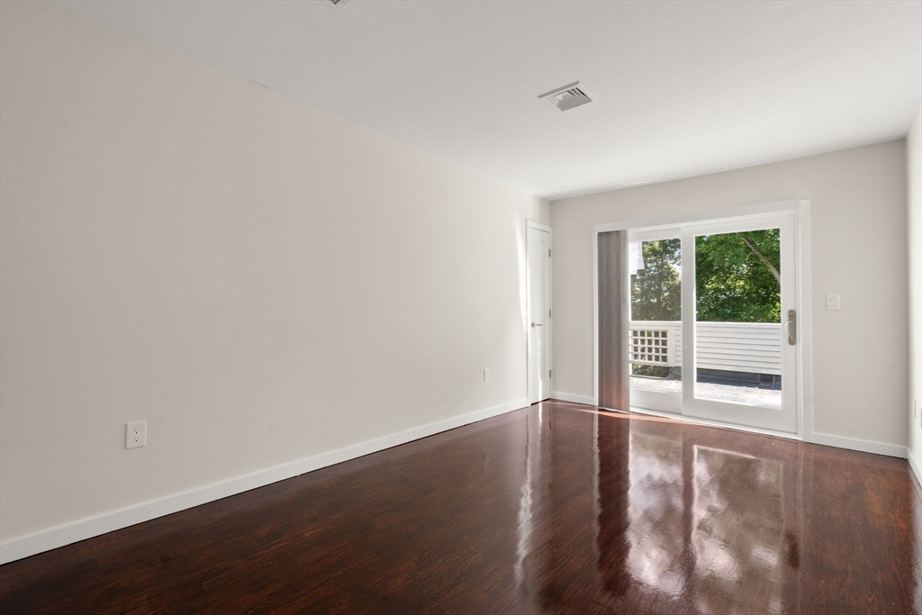 553 Boylston Street, Unit C2 Brookline, MA 02445 - Photo 19 of 31 a view of an empty room with wooden floor and a window