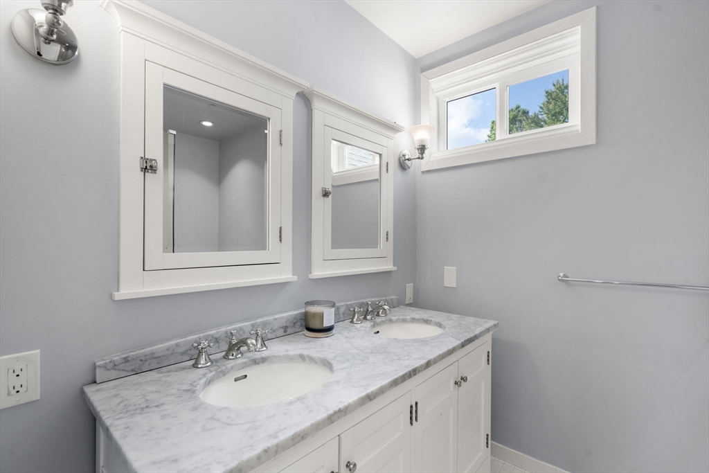 553 Boylston Street, Unit C2 Brookline, MA 02445 - Photo 20 of 31 a bathroom with a granite countertop sink a large mirror and a window