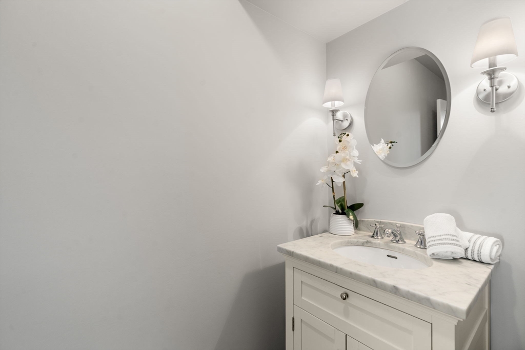 553 Boylston Street, Unit C2 Brookline, MA 02445 - Photo 6 of 31 a bathroom with a sink and a mirror