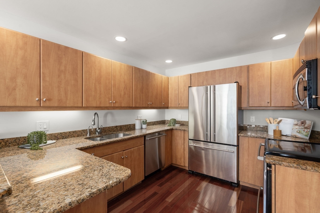 553 Boylston Street, Unit C2 Brookline, MA 02445 - Photo 7 of 31 a kitchen with stainless steel appliances granite countertop a sink refrigerator and cabinets