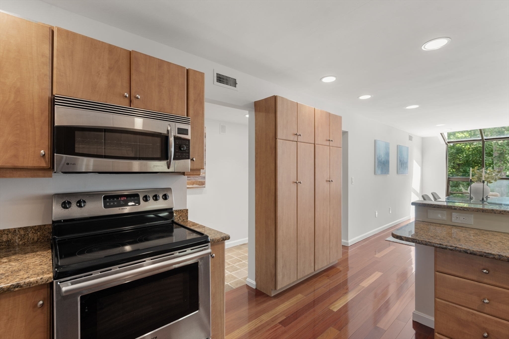 553 Boylston Street, Unit C2 Brookline, MA 02445 - Photo 9 of 31 a kitchen with stainless steel appliances a stove a microwave and a hard wood floors