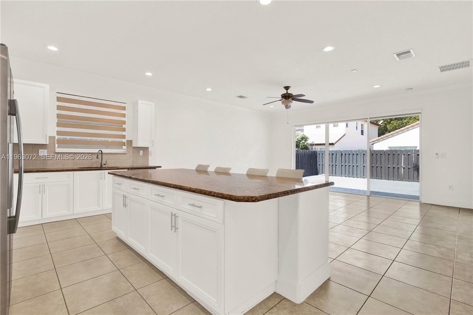 23824 Southwest 107th Place Homestead, FL 33032 - Photo 13 of 33 a kitchen with stainless steel appliances granite countertop a sink and cabinets