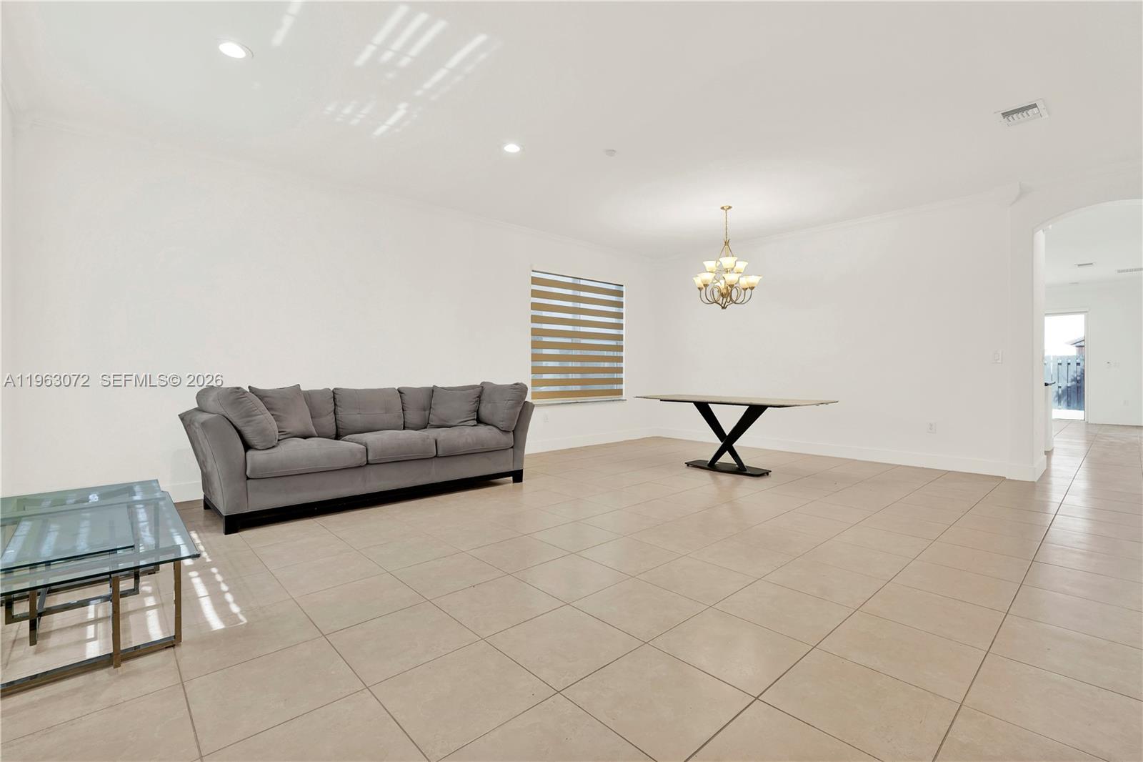 23824 Southwest 107th Place Homestead, FL 33032 - Photo 15 of 33 a living room with furniture and a chandelier