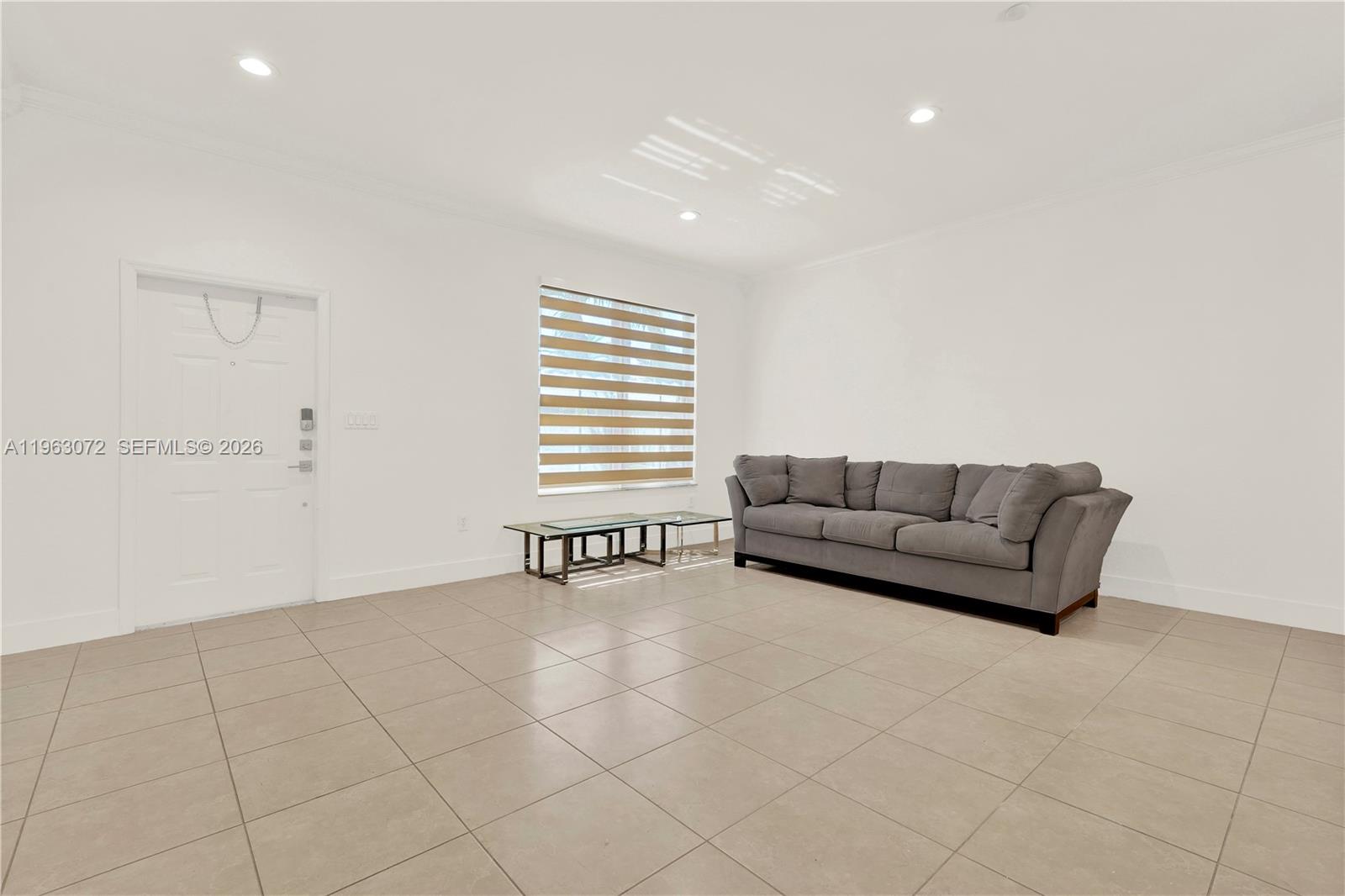 23824 Southwest 107th Place Homestead, FL 33032 - Photo 16 of 33 a living room with furniture and a window
