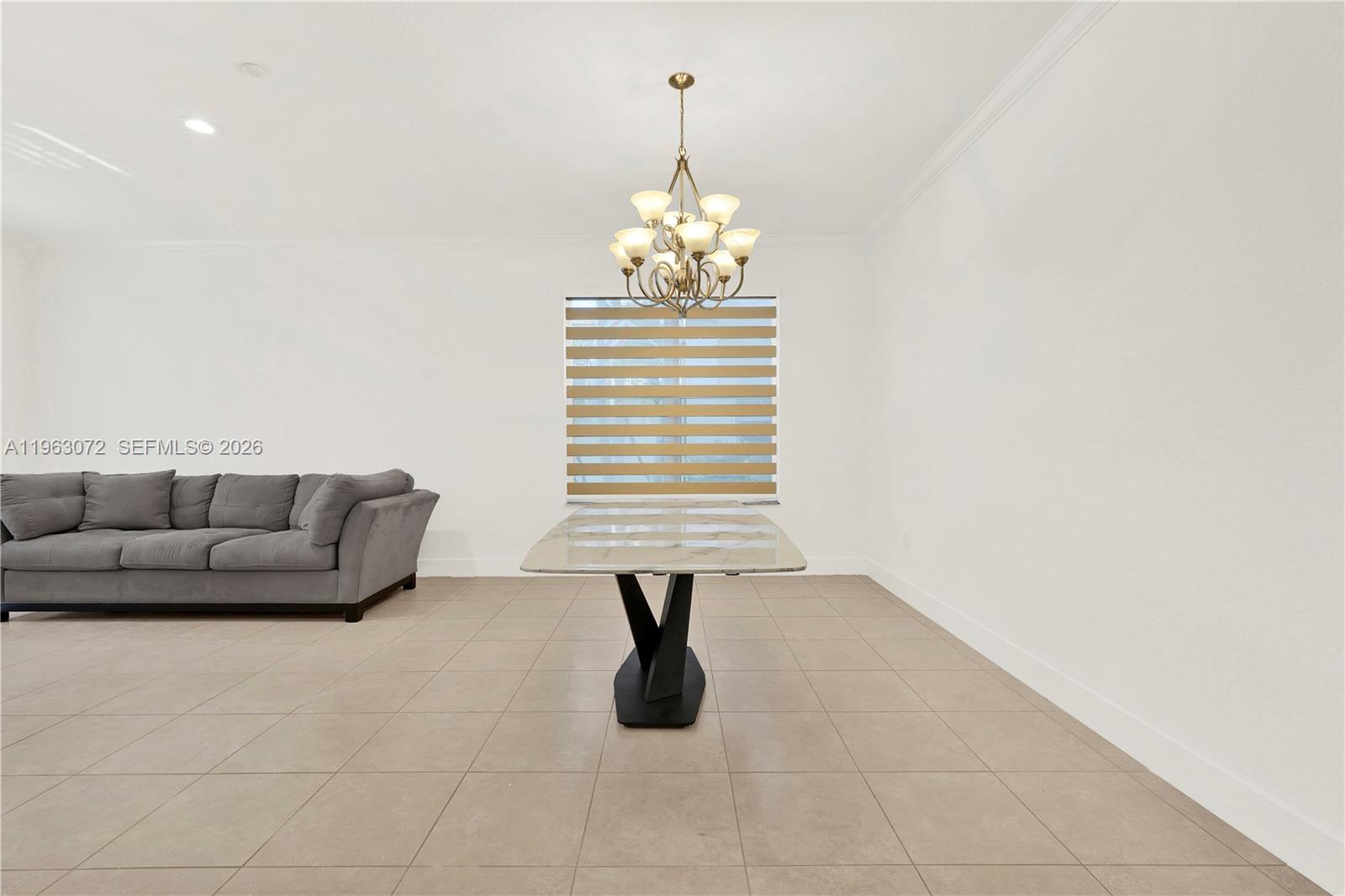 23824 Southwest 107th Place Homestead, FL 33032 - Photo 17 of 33 a living room with furniture and a chandelier