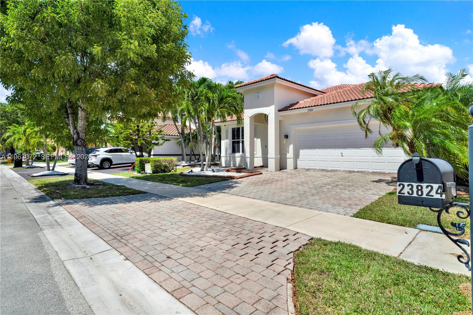 23824 Southwest 107th Place Homestead, FL 33032 - Photo 2 of 33 a view of a street with houses on the roadside