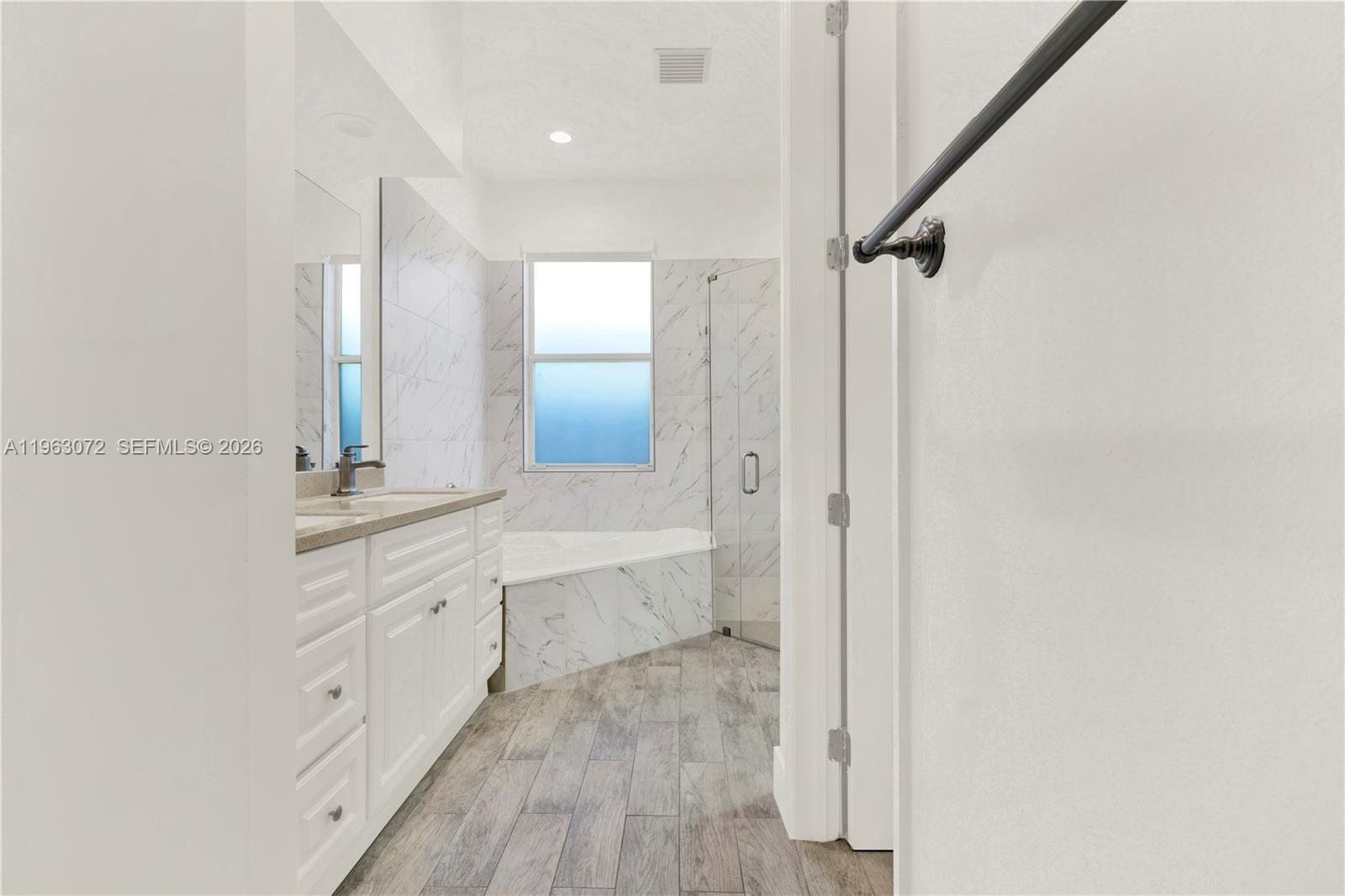 23824 Southwest 107th Place Homestead, FL 33032 - Photo 23 of 33 a bathroom with a double vanity sink toilet mirror and bathtub