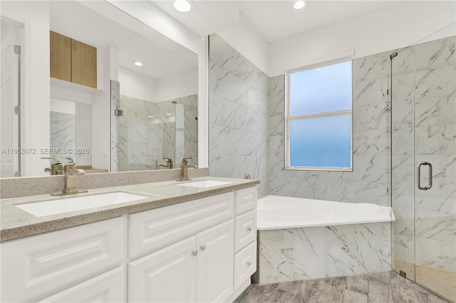 23824 Southwest 107th Place Homestead, FL 33032 - Photo 27 of 33 a bathroom with a sink double vanity granite tub shower and a mirror