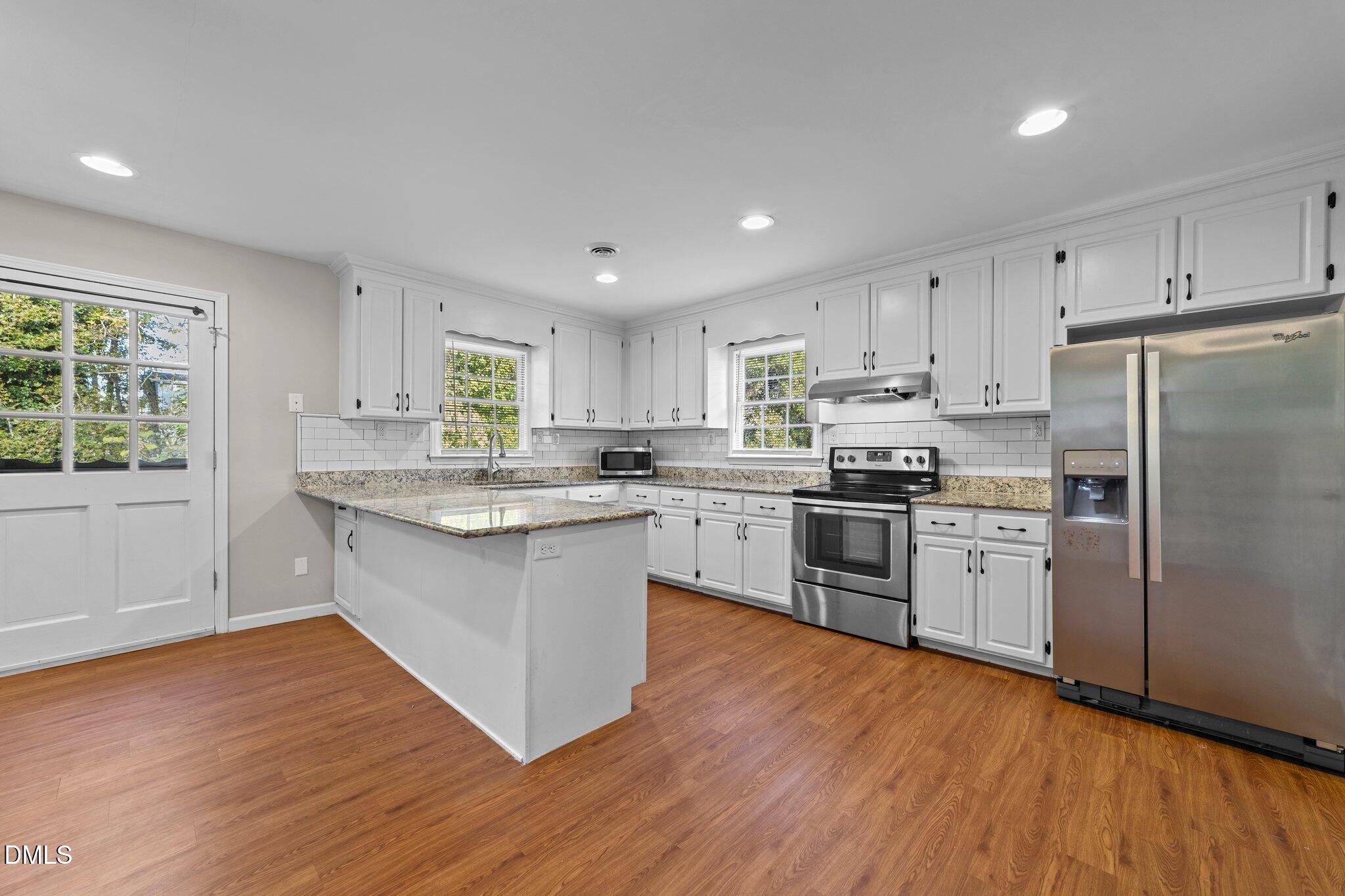 412 2nd Street Apex, NC 27502 - Photo 11 of 39 a kitchen with a refrigerator sink and cabinets