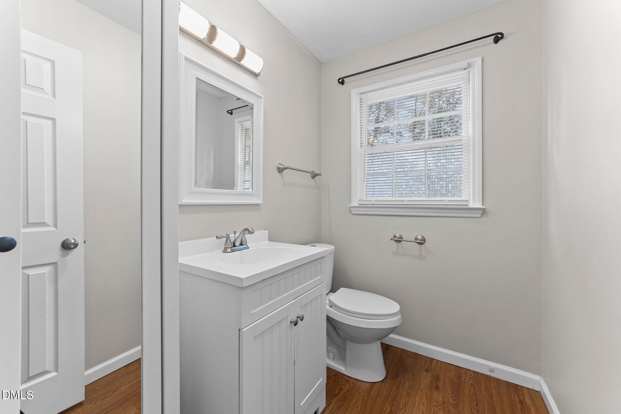 412 2nd Street Apex, NC 27502 - Photo 18 of 39 a bathroom with a toilet sink and mirror