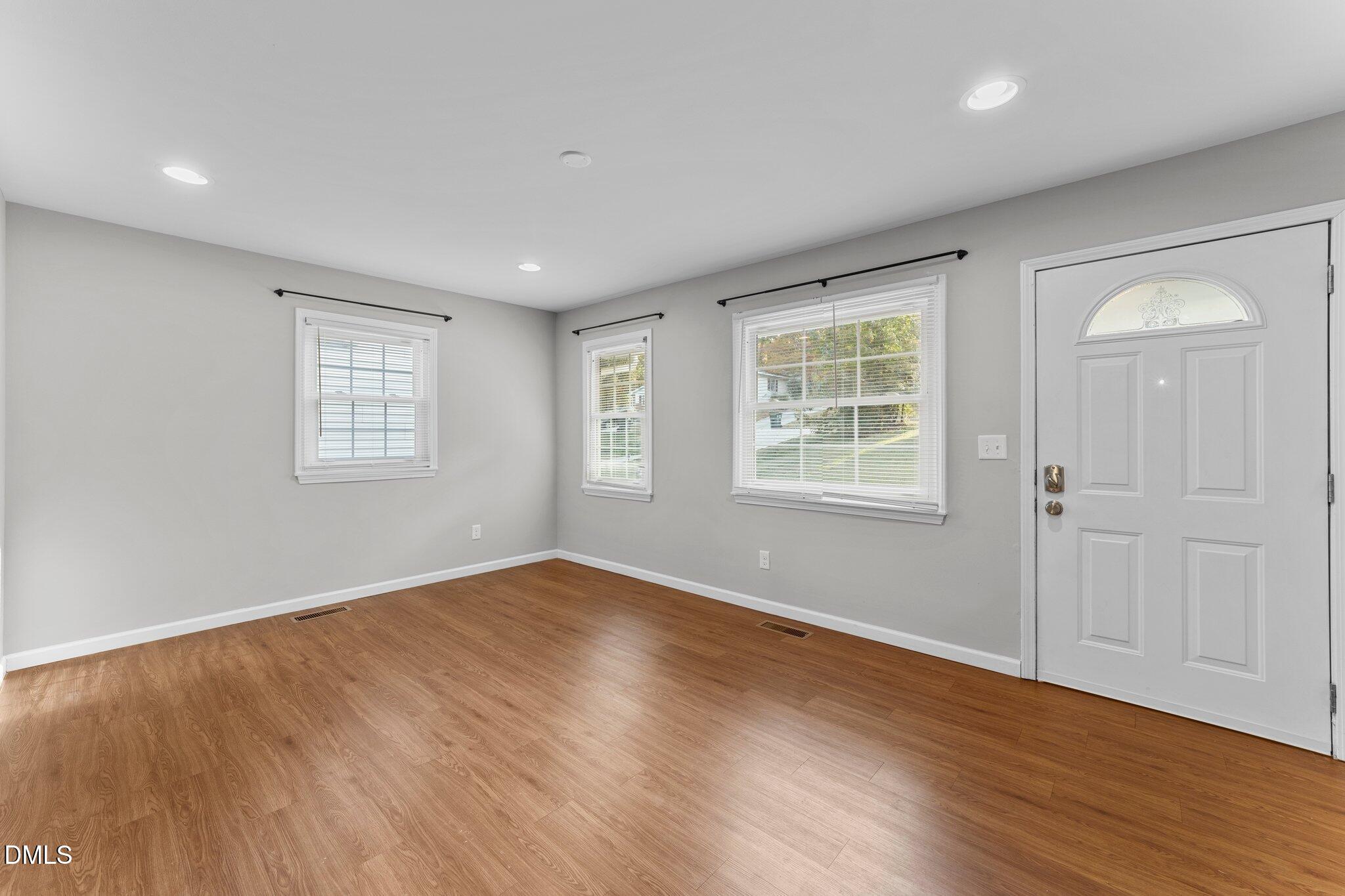 412 2nd Street Apex, NC 27502 - Photo 2 of 39 an empty room with wooden floor and windows